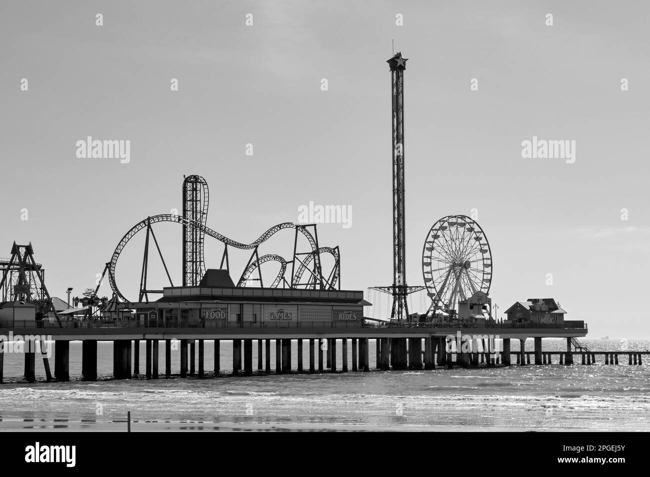 Galveston, Texas, USA - February 2023: Fairground at the end of the city's historic pier in black and white Stock Photo
