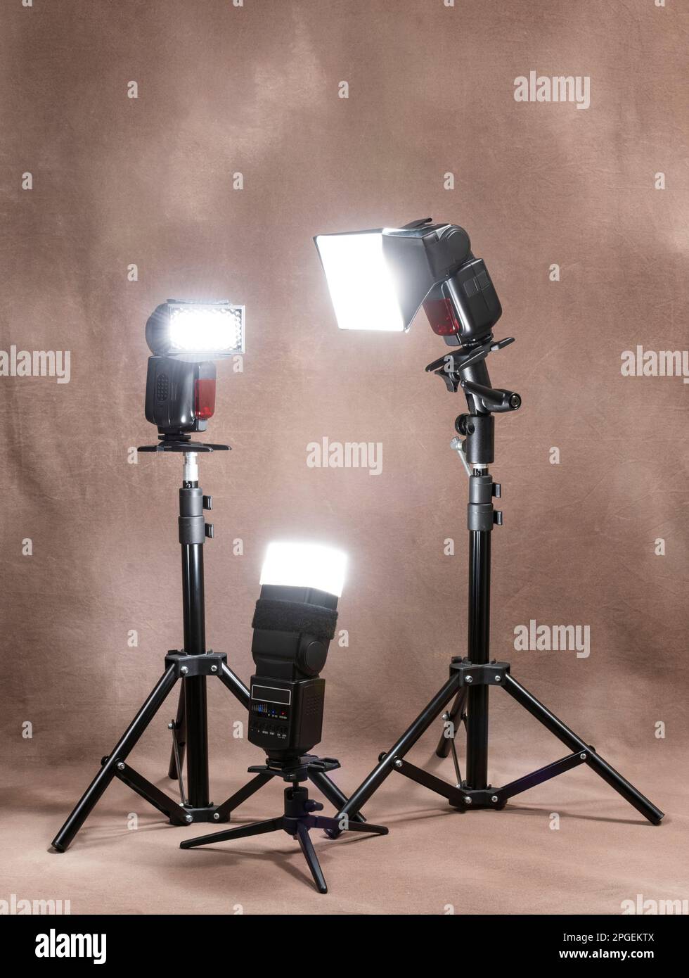 Vertical shot of three radiocontrolled electronic strobes on tripods