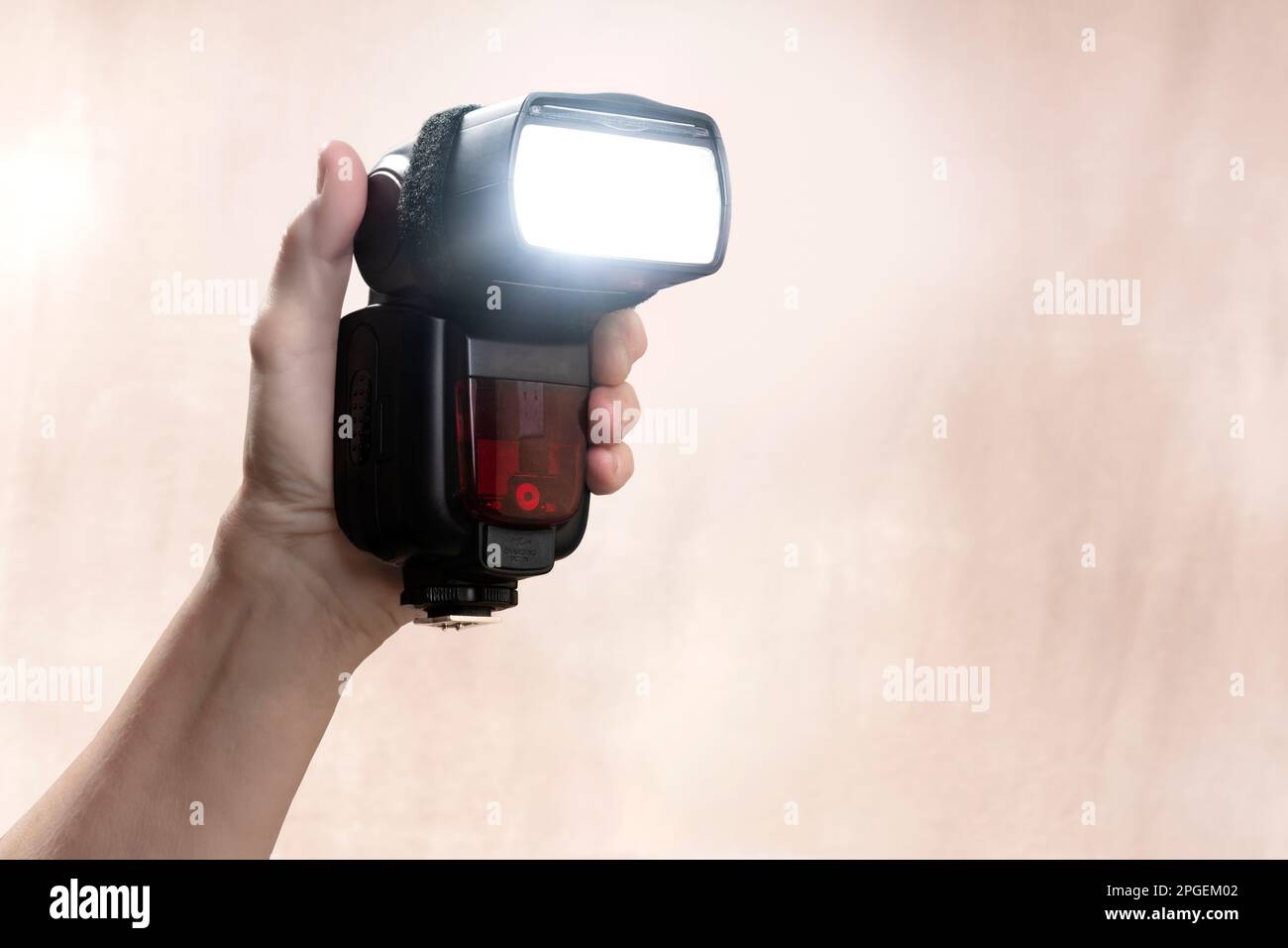 Horizontal shot of a hand held radio-controlled electronic flash with copy space. Stock Photo