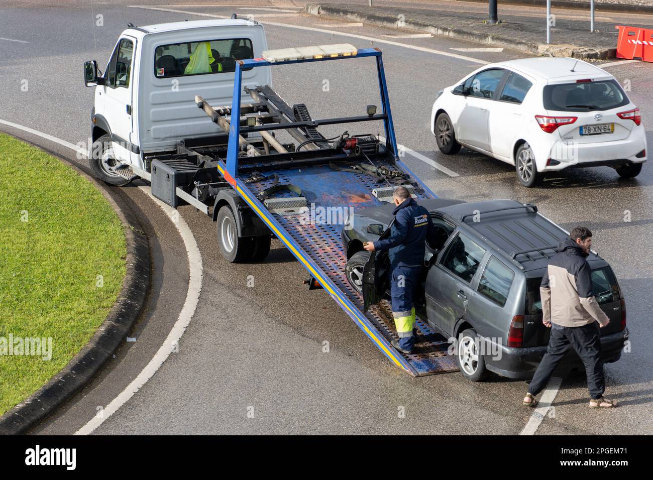 Damaged car being loaded onto a tow truck Stock Photo