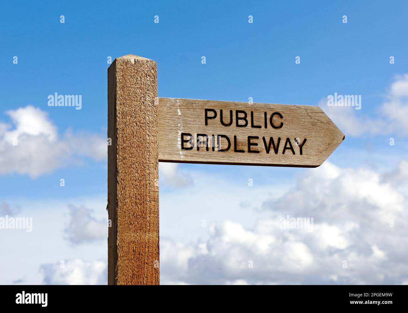 A view of a fingerpost indicating direction of a Public Bridleway across farmland in the North Norfolk countryside at Dilham, Norfolk, England, UK. Stock Photo