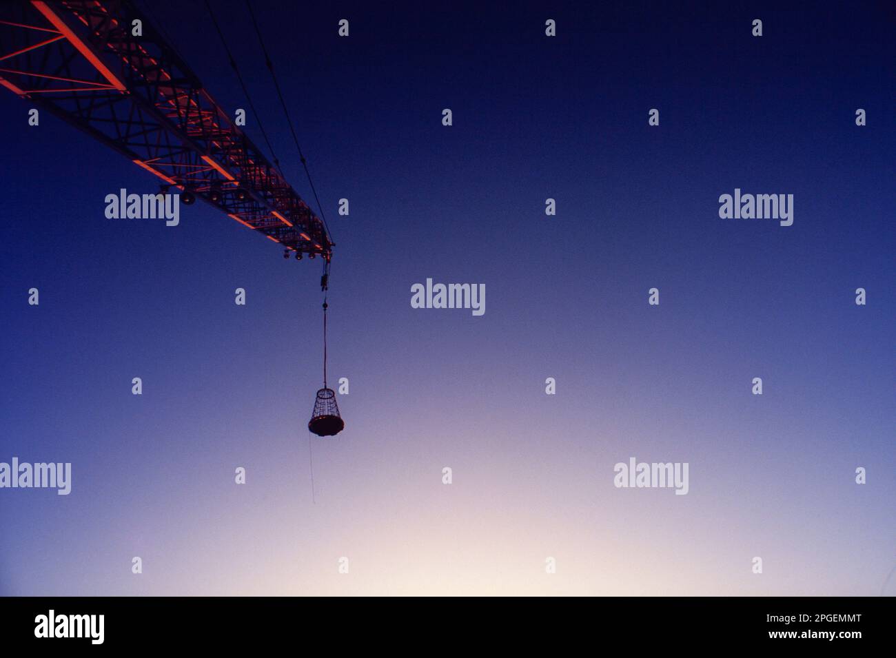 Basket designed to put worker at difficult to reach places hanged on a crane in an offshore oil platform. Campos Basin, Rio de Janeiro State, Brazil. Stock Photo