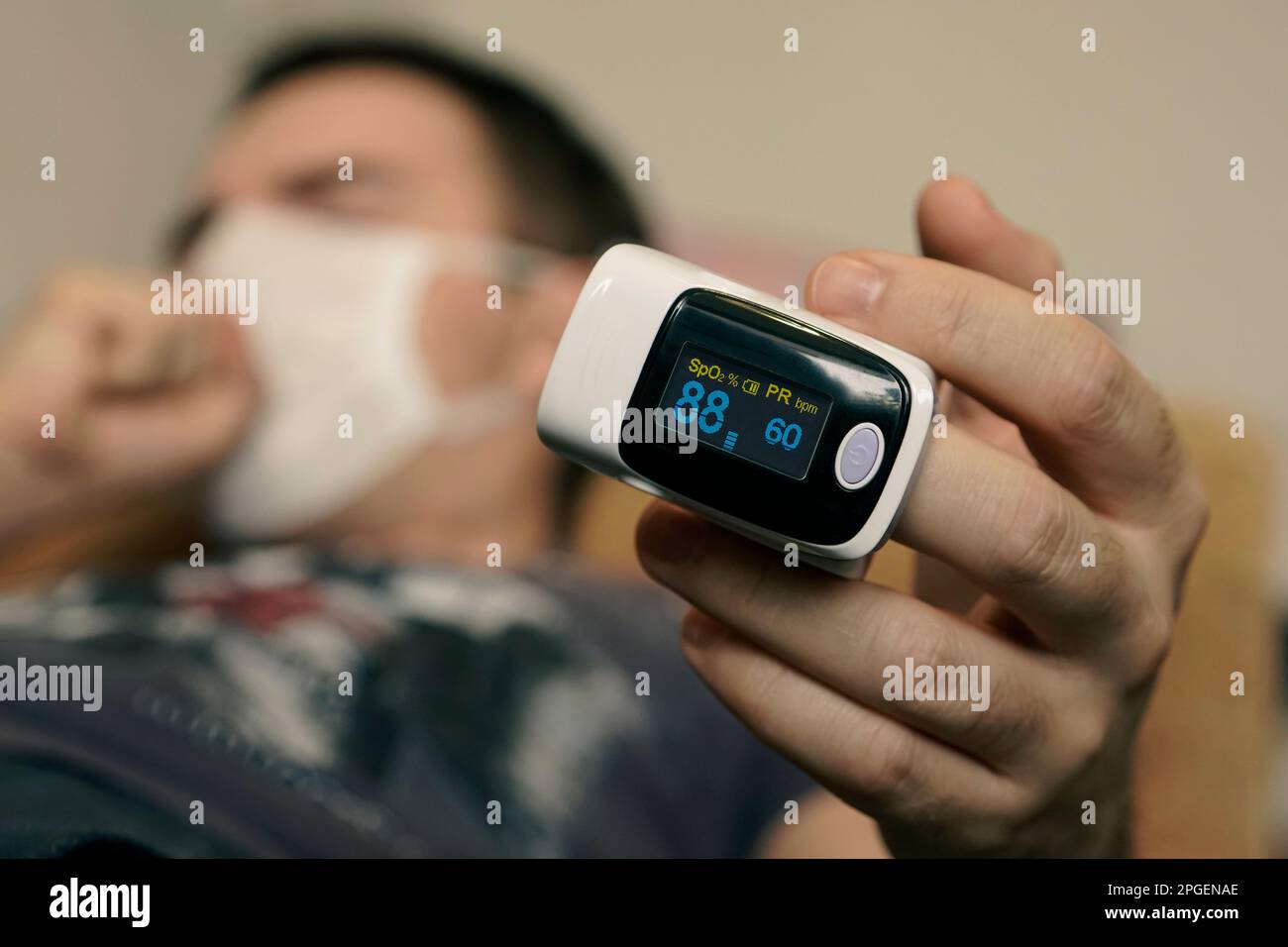 pulse oximeter on a mans finger. oxygen saturation of the blood. A