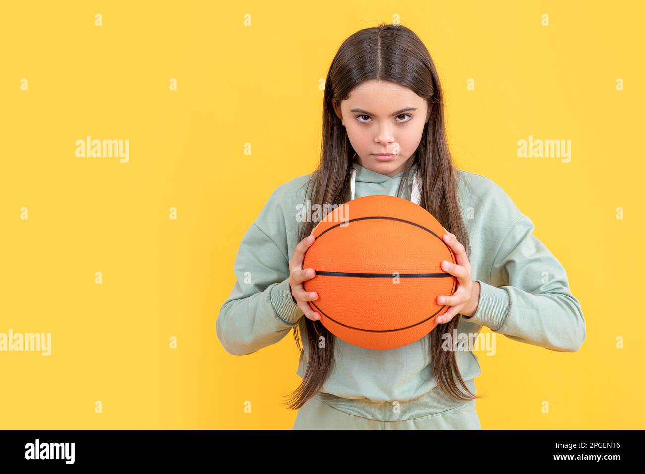 serious teen basketball girl on background. photo of teen basketball