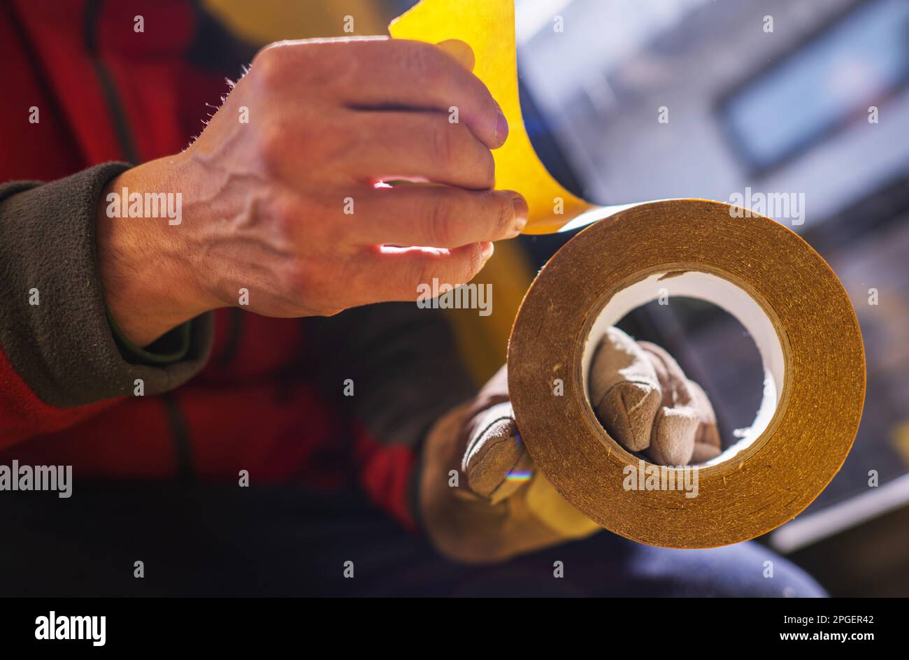 Caucasian Man Using Double Sided Tape Close Up Photo. Stock Photo