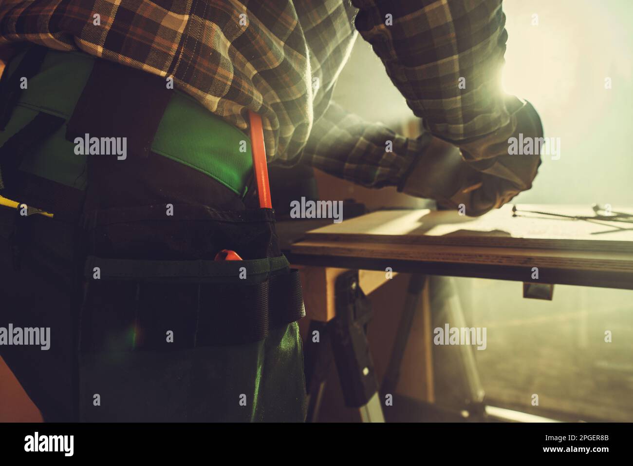 Handyman Working Inside His Small Workshop Close Up Photo. Small Construction Job. Stock Photo