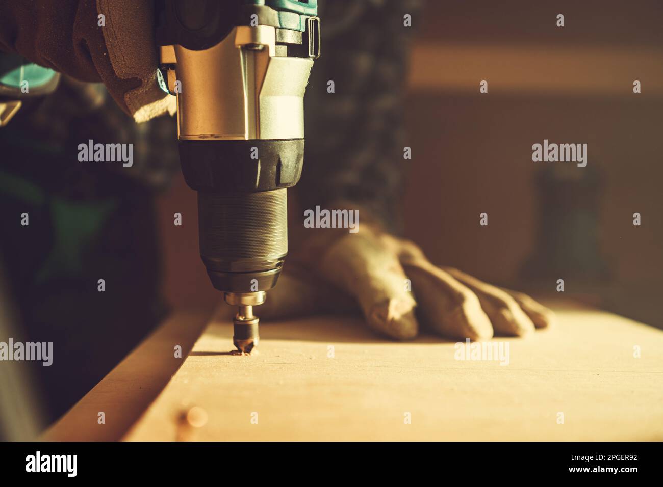 Woodwork Project Theme. Spinning Drill Driver with Wood Boring Bit Attached Close Up. Stock Photo