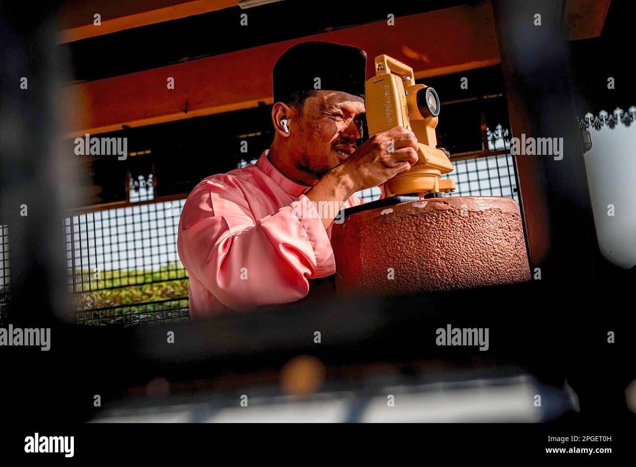 An official from the Selangor Islamic Religious Council is performing 'rukyah', a moon sighting ceremony to determine the start date of the holy month of Ramadan in Bukit Malawati. Stock Photo