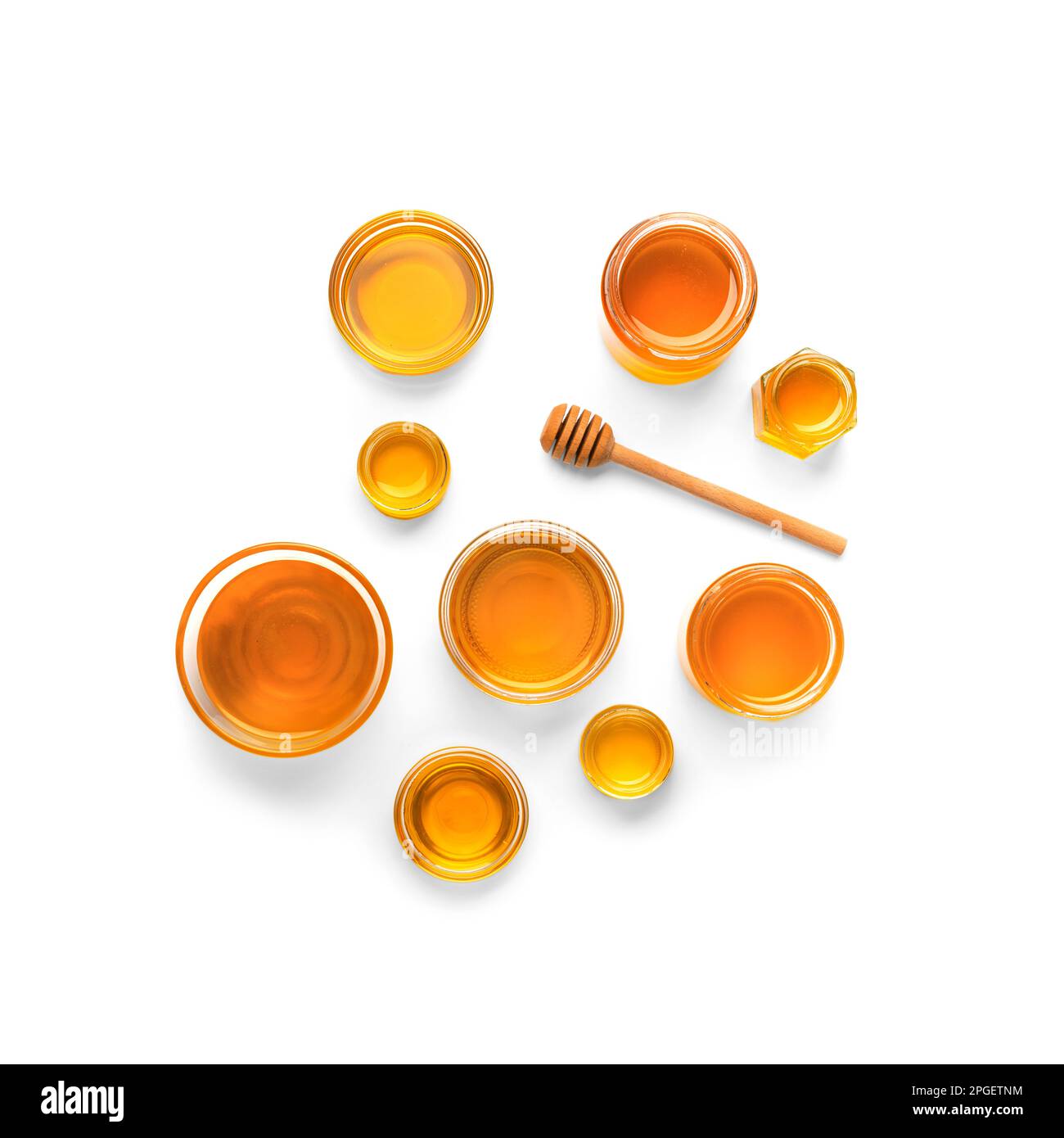 Creative composition of honey jars and dipper on isolation. Honey in a glass dish of different