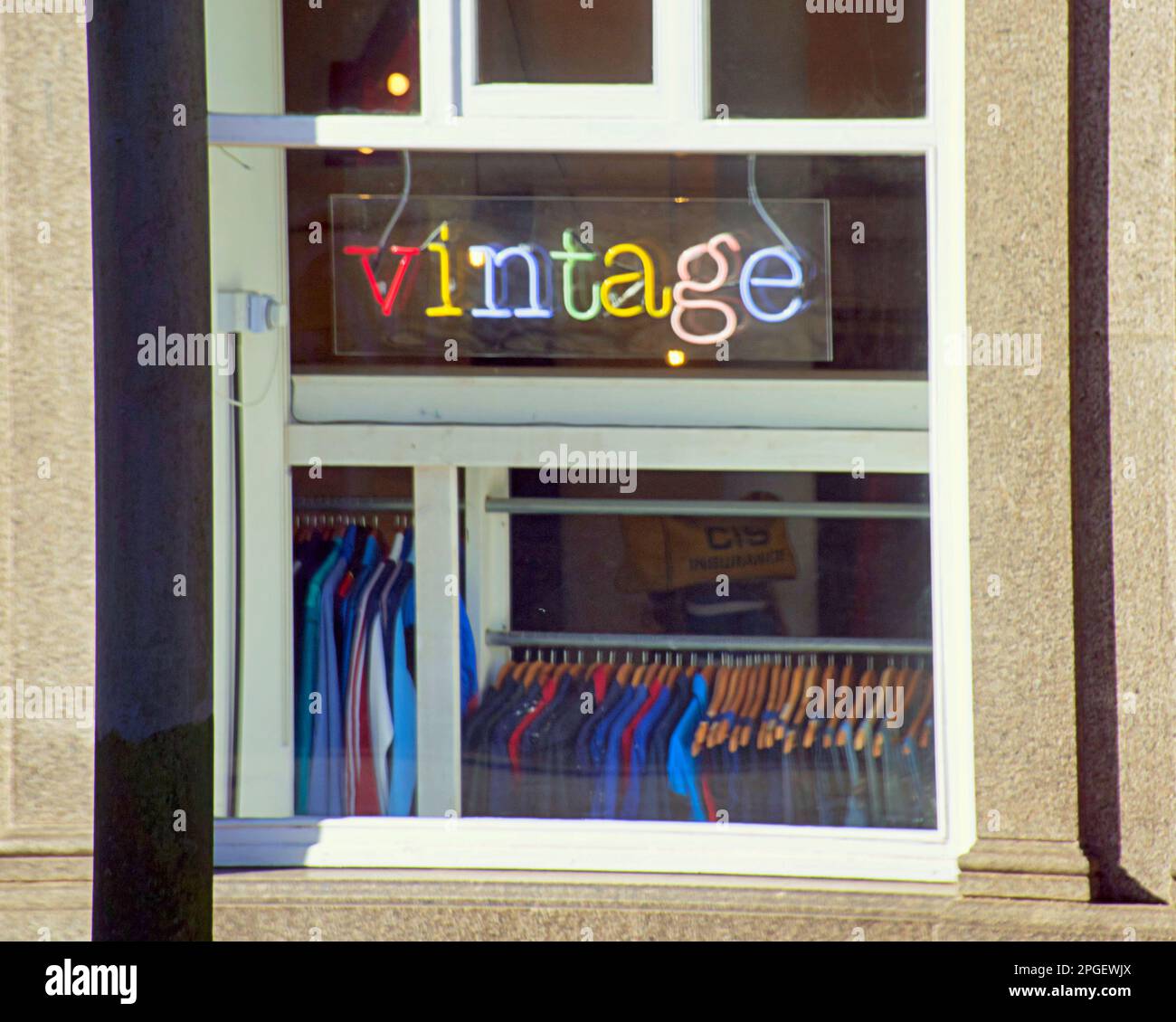 vintage clothes shop sign in window Stock Photo