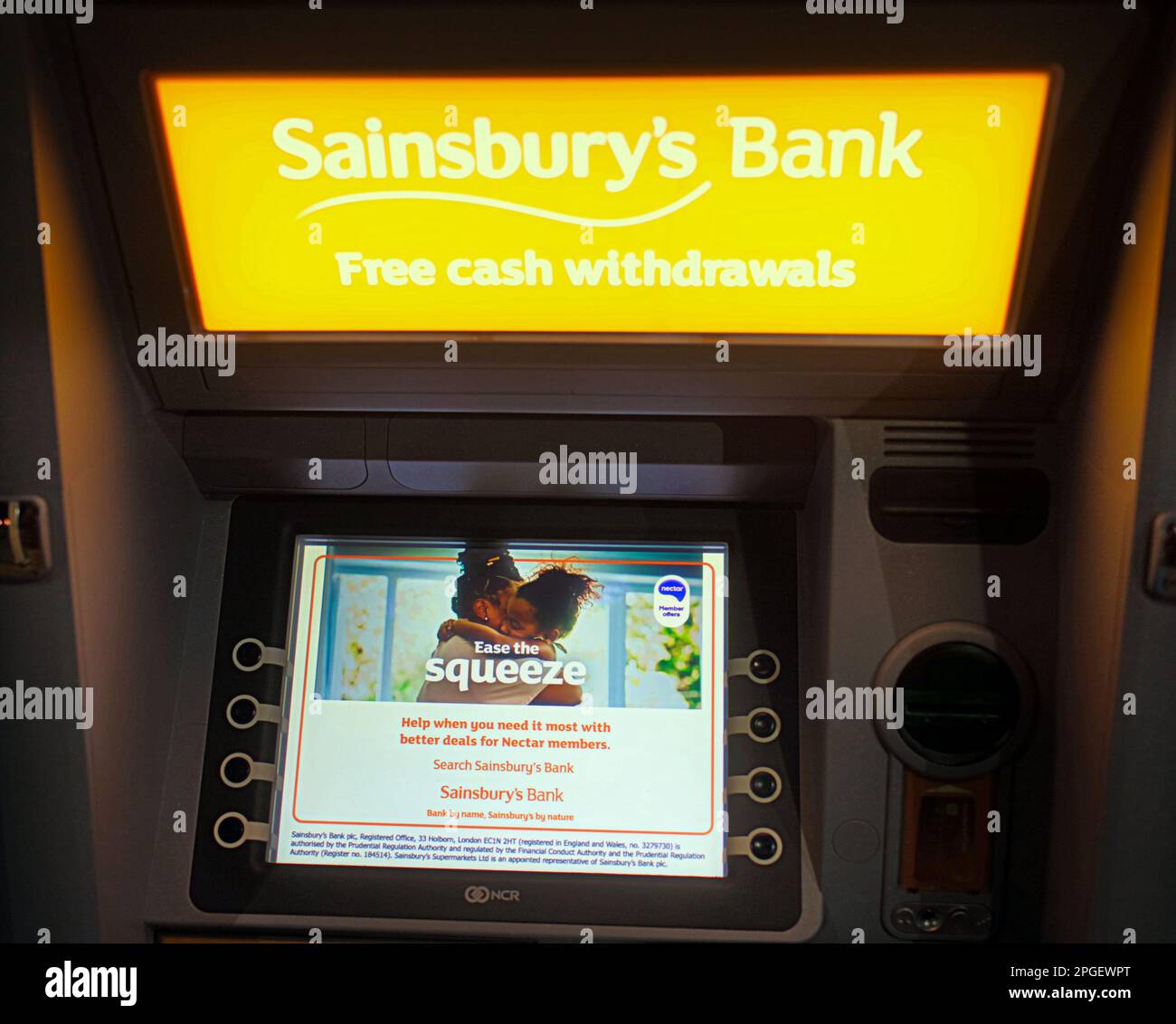 Sainsburys bank atm cash machine with feel the squeeze message Stock Photo