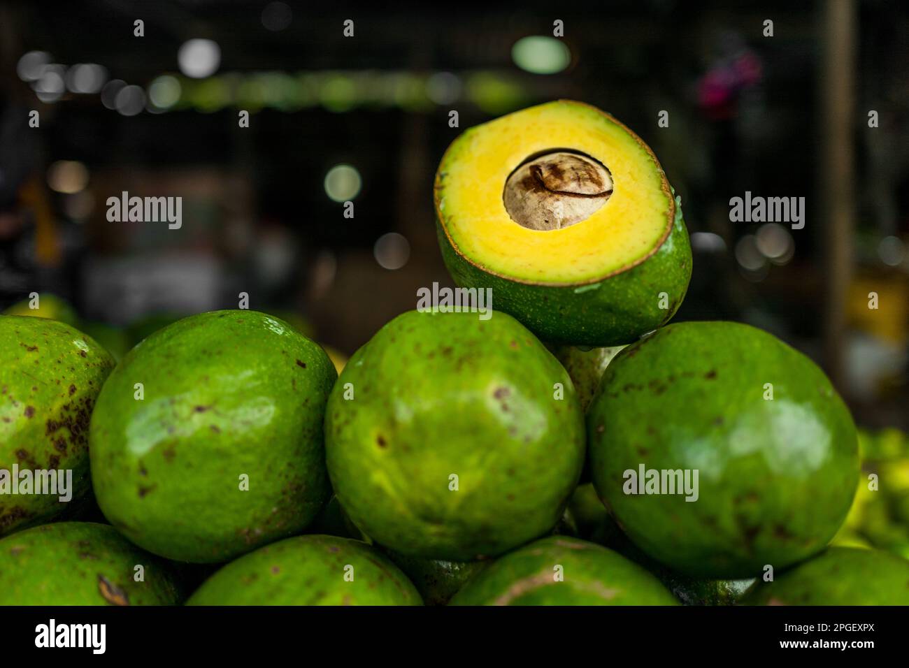 Fresh and ripe avocados are seen arranged on the market stand for sale in the street market in Barranquilla, Colombia. Stock Photo