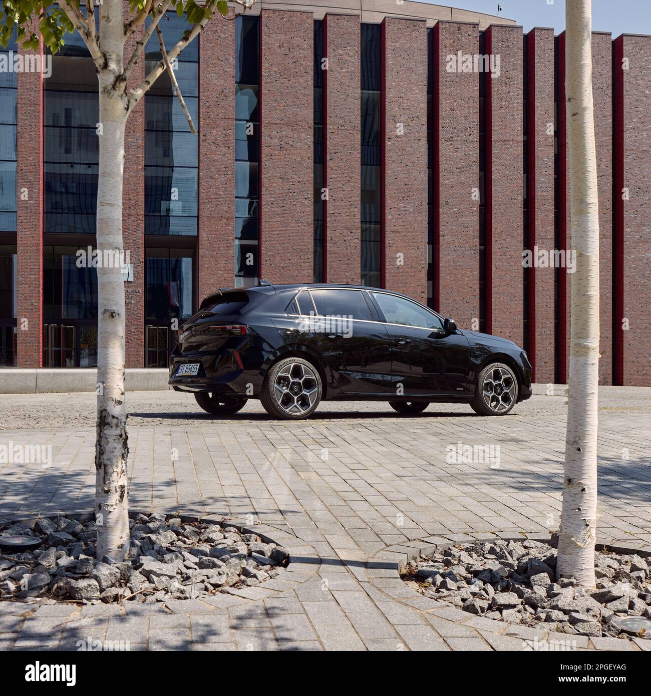 Black Opel Astra hatchback, parked in front of the philharmonic building. Model 2022, sixth generation. 24.07.2022, Katowice, Poland Stock Photo
