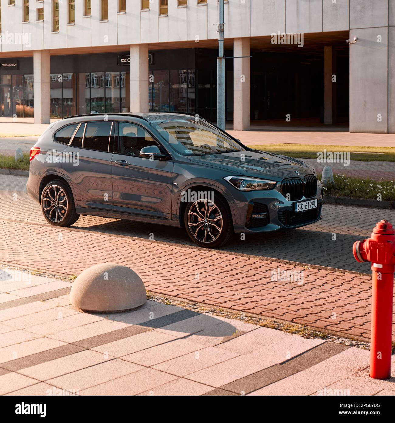 BMW X1 25e, hybrid, plug in car, parked next to a modern building. The  total power of both engines is 220HP. Electric range up to 52 km  Katowice/Polan Stock Photo - Alamy