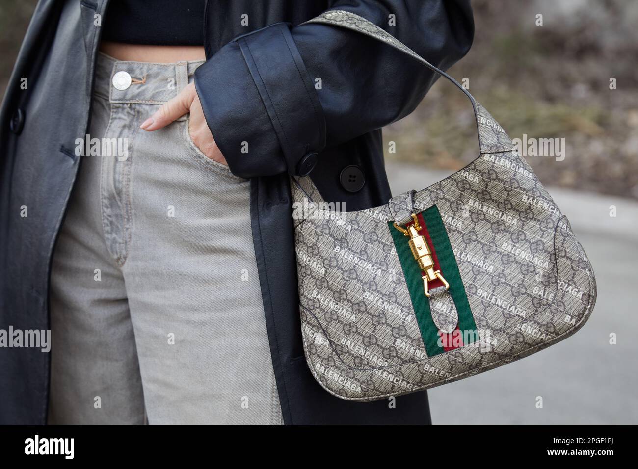 MILAN, ITALY - FEBRUARY 24, 2023: Woman with blue denim Louis Vuitton bag  before Gucci fashion show, Milan Fashion Week street style Stock Photo -  Alamy