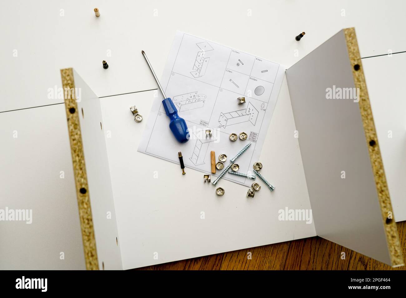 New white laminated chipboard furniture self mounting set with fitting screws, wooden pins