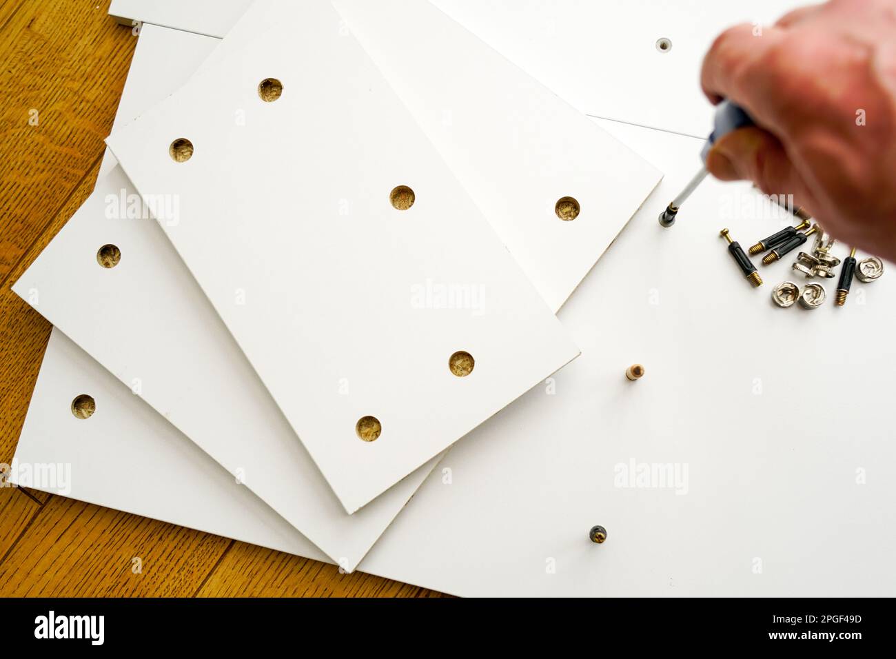 New white laminated chipboard furniture self mounting set with fitting screws, wooden pins