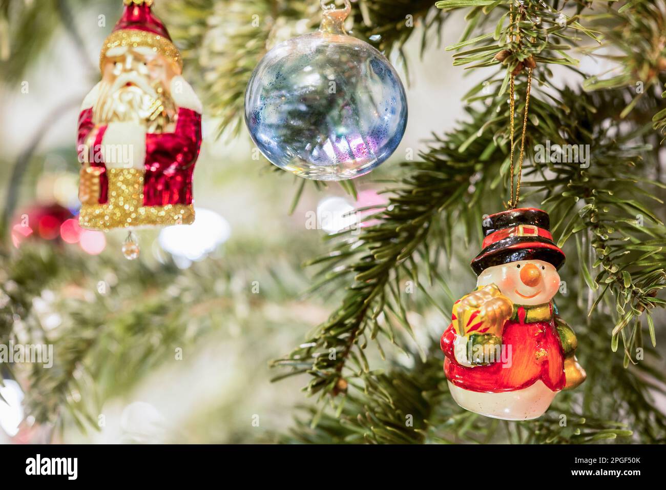 Christmas baubles and Santa Claus hanging on Christmas tree, Munich, Germany Stock Photo