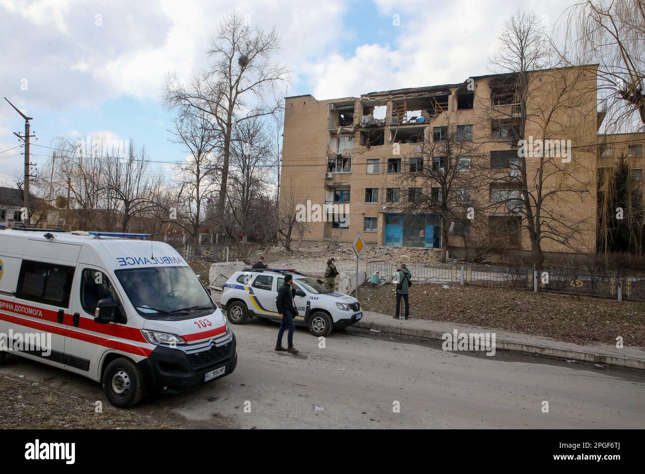KYIV REGION, UKRAINE - MARCH 22 , 2023 - Ambulances and police cars are parked next to the dormitory destroyed by a Russian nighttime drone attack, Rzhyshchiv, Kyiv Region, central Ukraine. Stock Photo