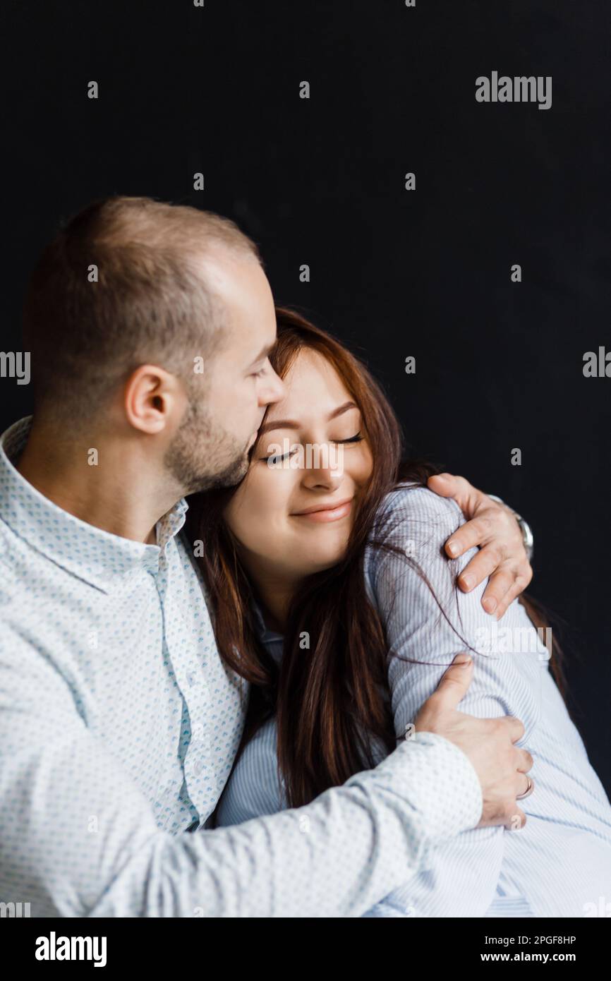 Hugging Poste man and a woman in love pose for a family portrait, hugging Stock Photo ...