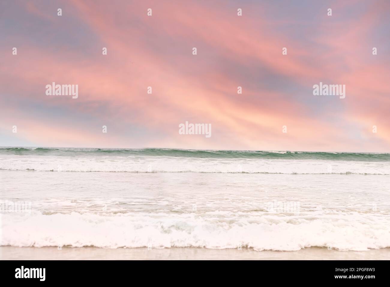 Pink sunset over the ocean waves Stock Photo