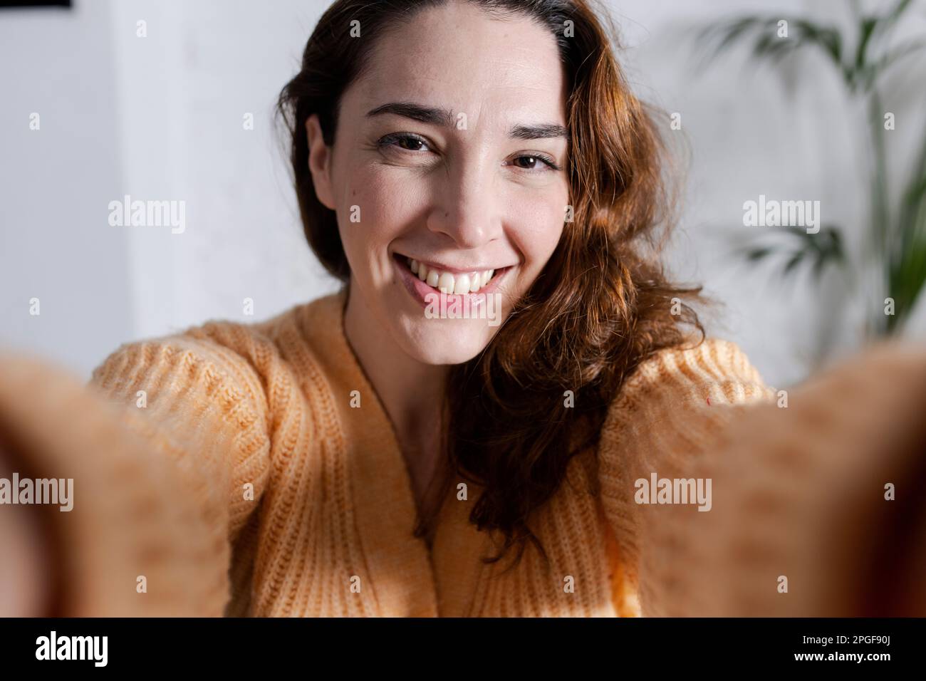 smiling beautiful young woman taking a selfie in home Stock Photo - Alamy