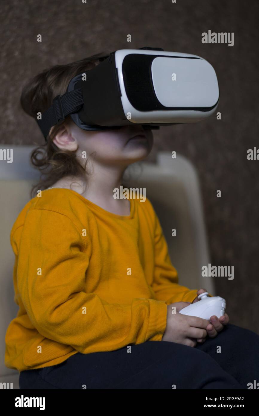 little child playing virtual games in vr glasses Stock Photo Alamy