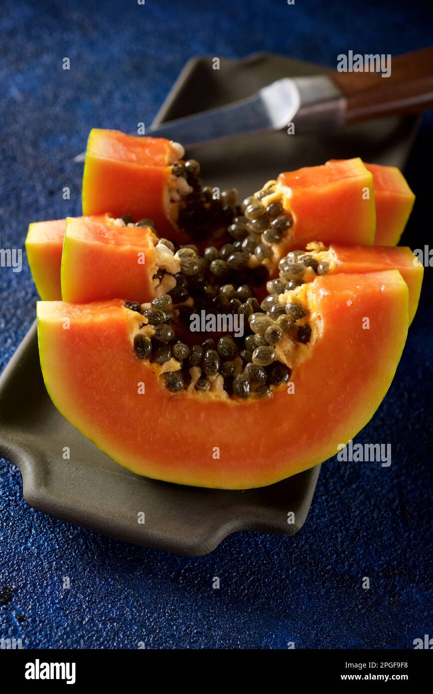 Papaya chunks in a stone tray Stock Photo Alamy