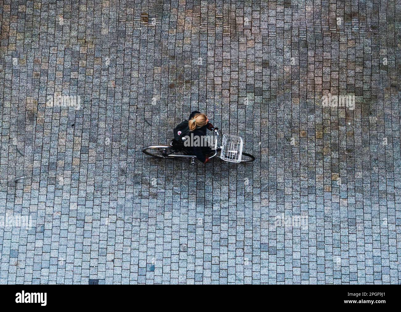 aerial or bird's eye view of a person riding a bike down the street