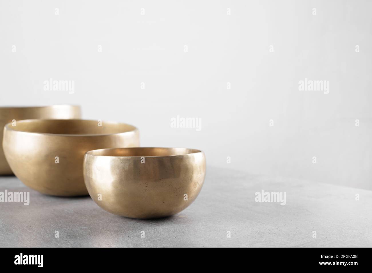 Singing Table Create Tibetan singing bowls on stone table background Stock Photo - Alamy