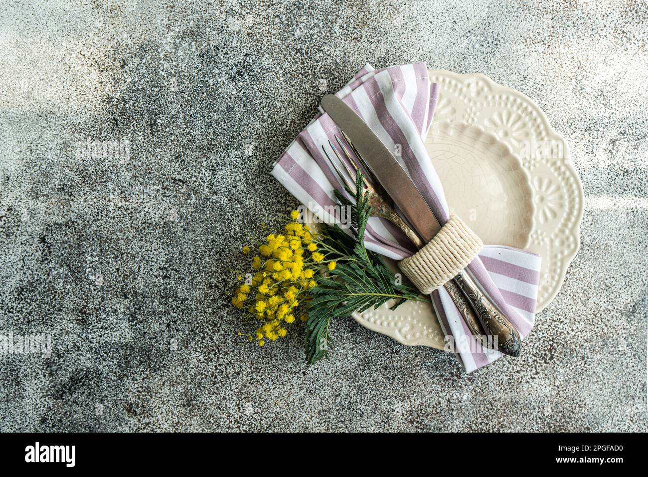 Easte dinner set with yellow mimosa flowers Stock Photo