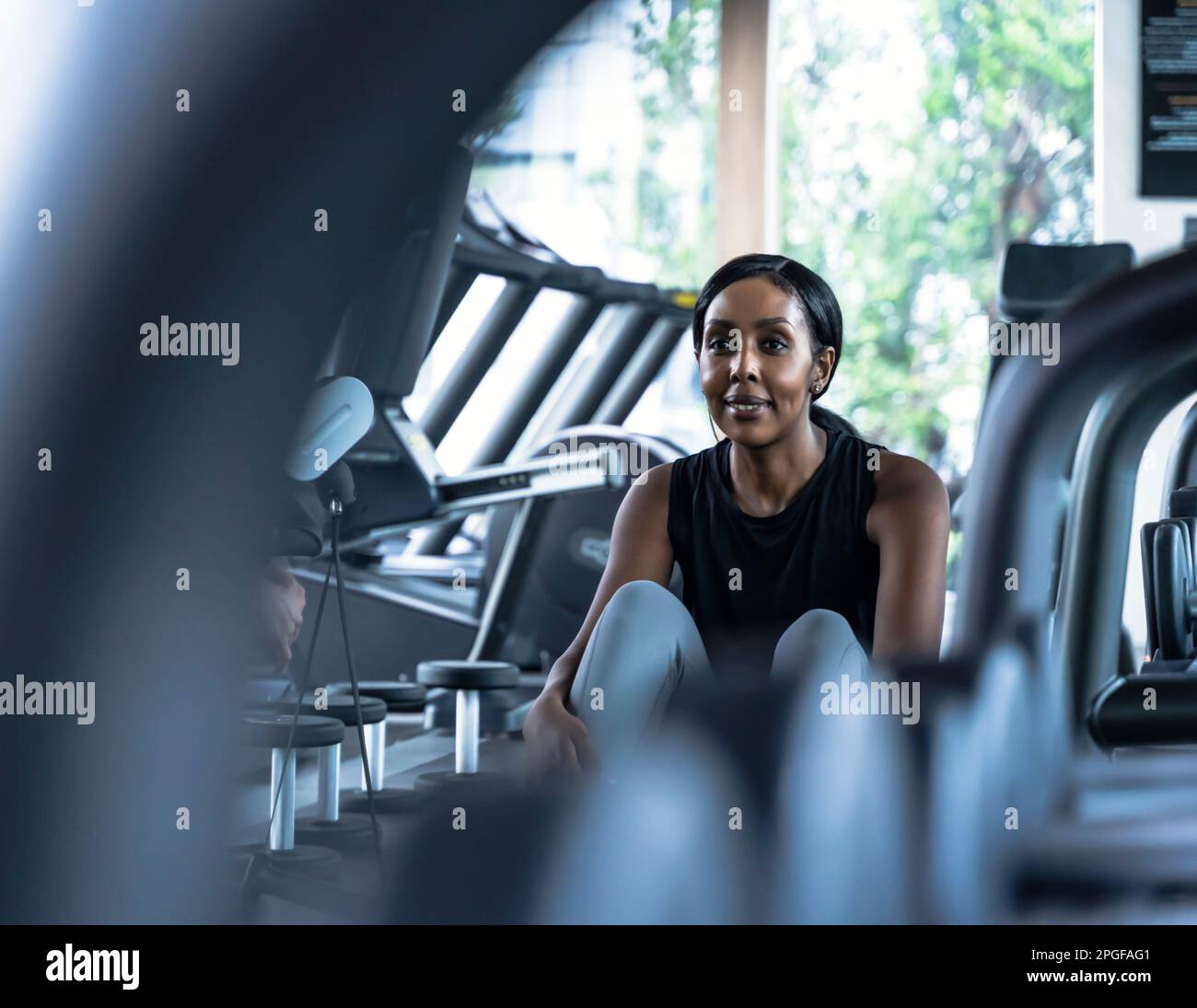 Portrait confident black woman resting at gym Stock Photo - Alamy
