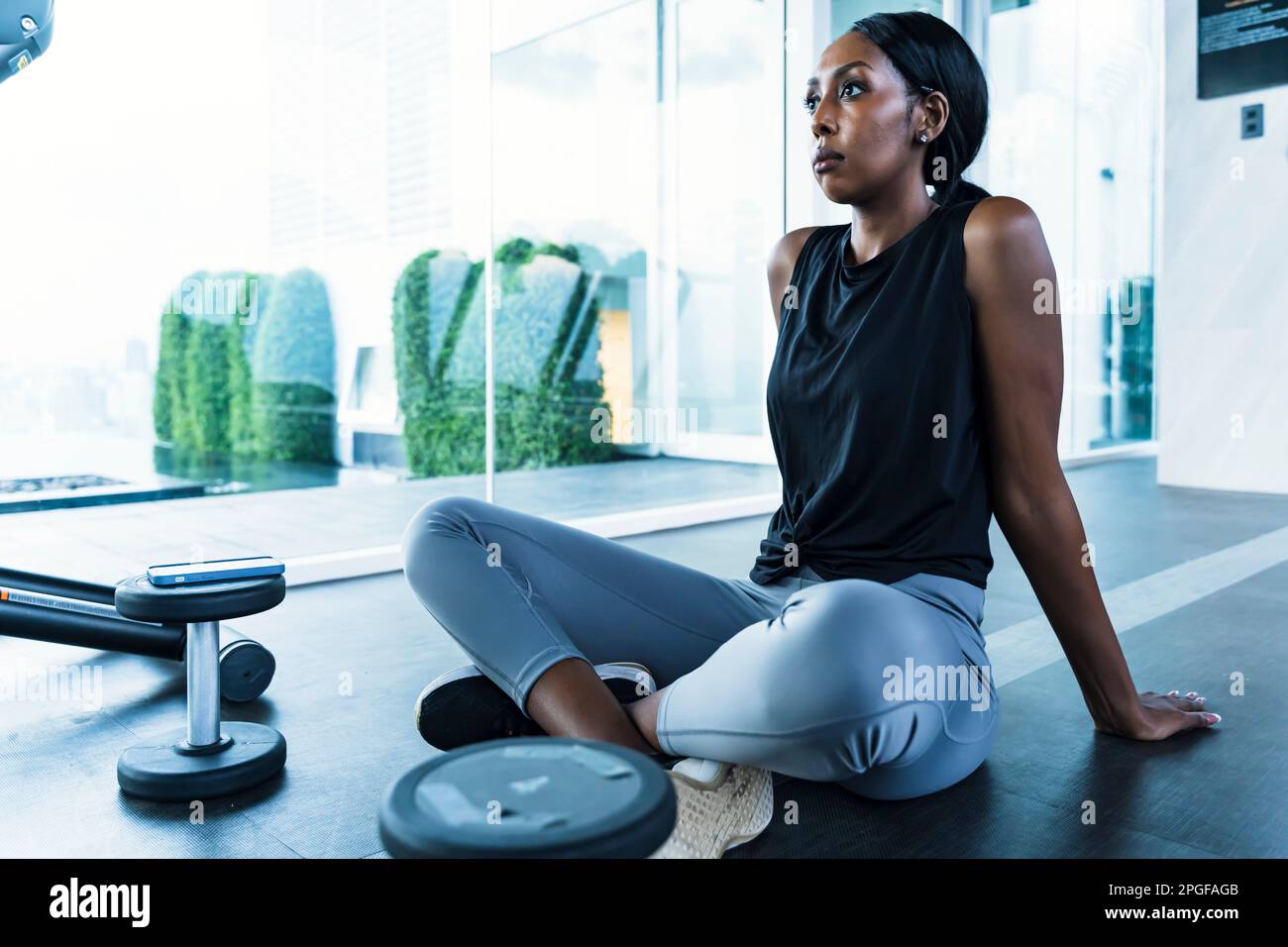 Portrait confident black woman resting at gym Stock Photo - Alamy
