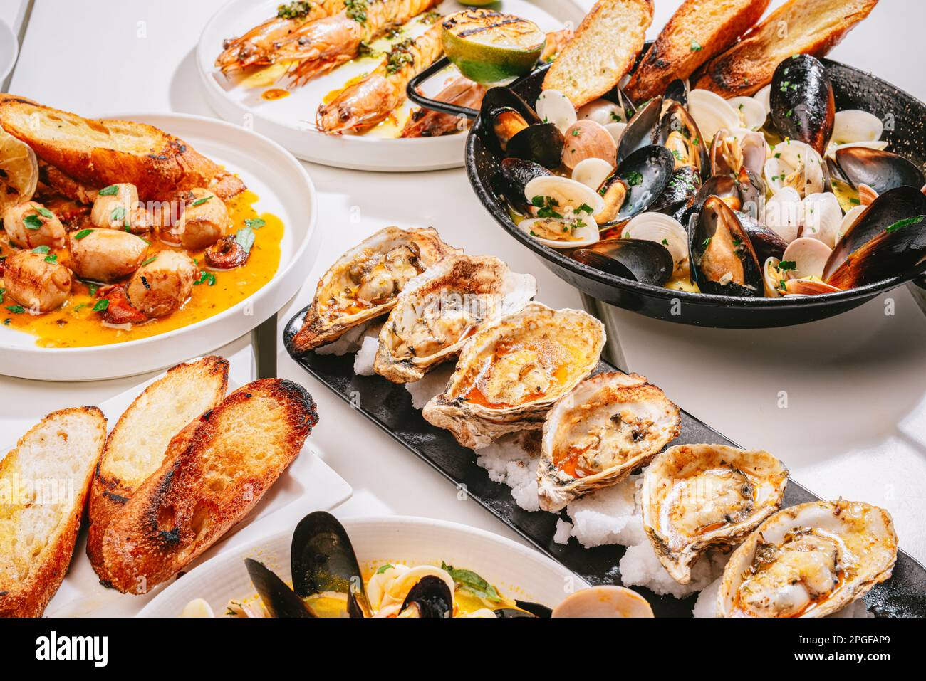 four different seafood dishes in the table Stock Photo Alamy