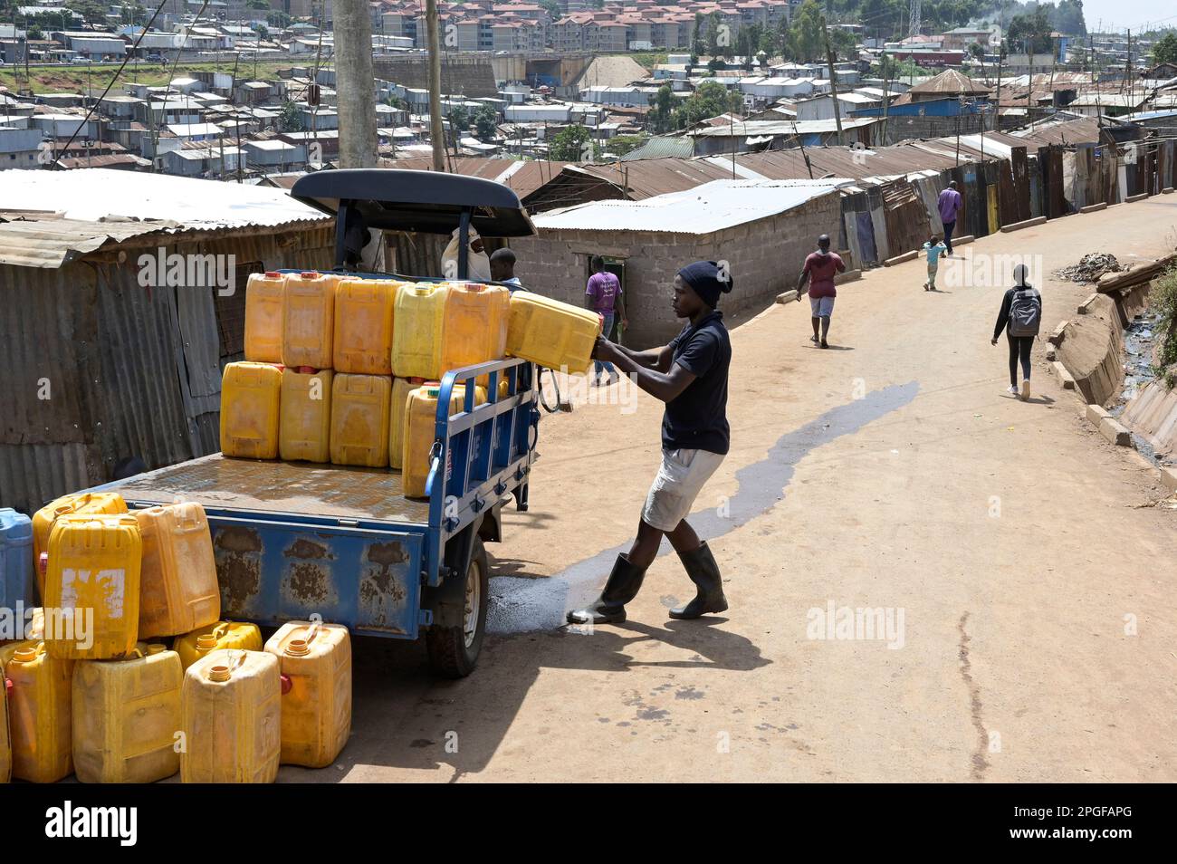 KENYA, Nairobi, Kibera slum, water transport in jerry cans / KENIA