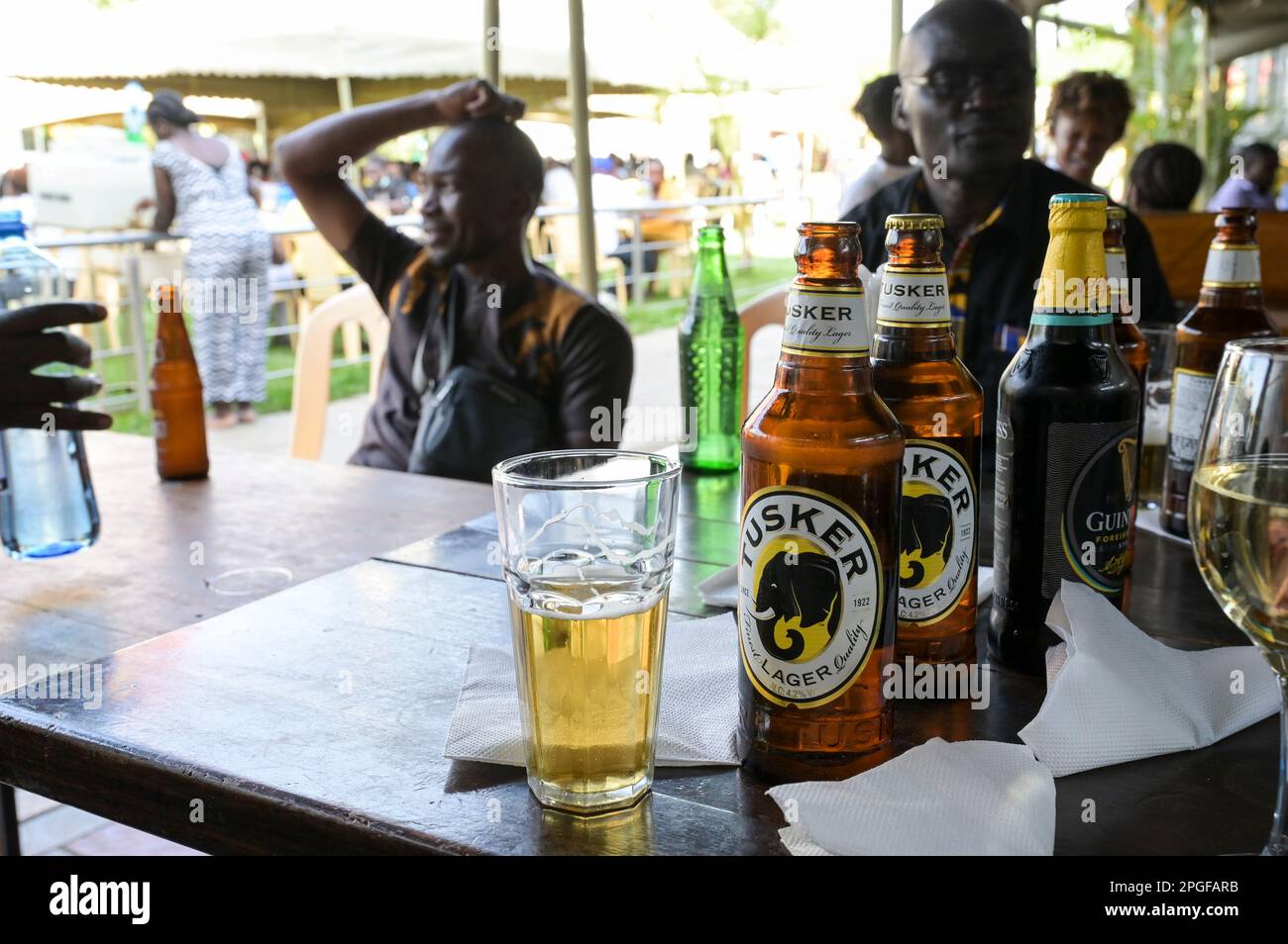 KENYA, Nairobi, middle class in beer garden, Tusker beer and Guinness beear, brands of british