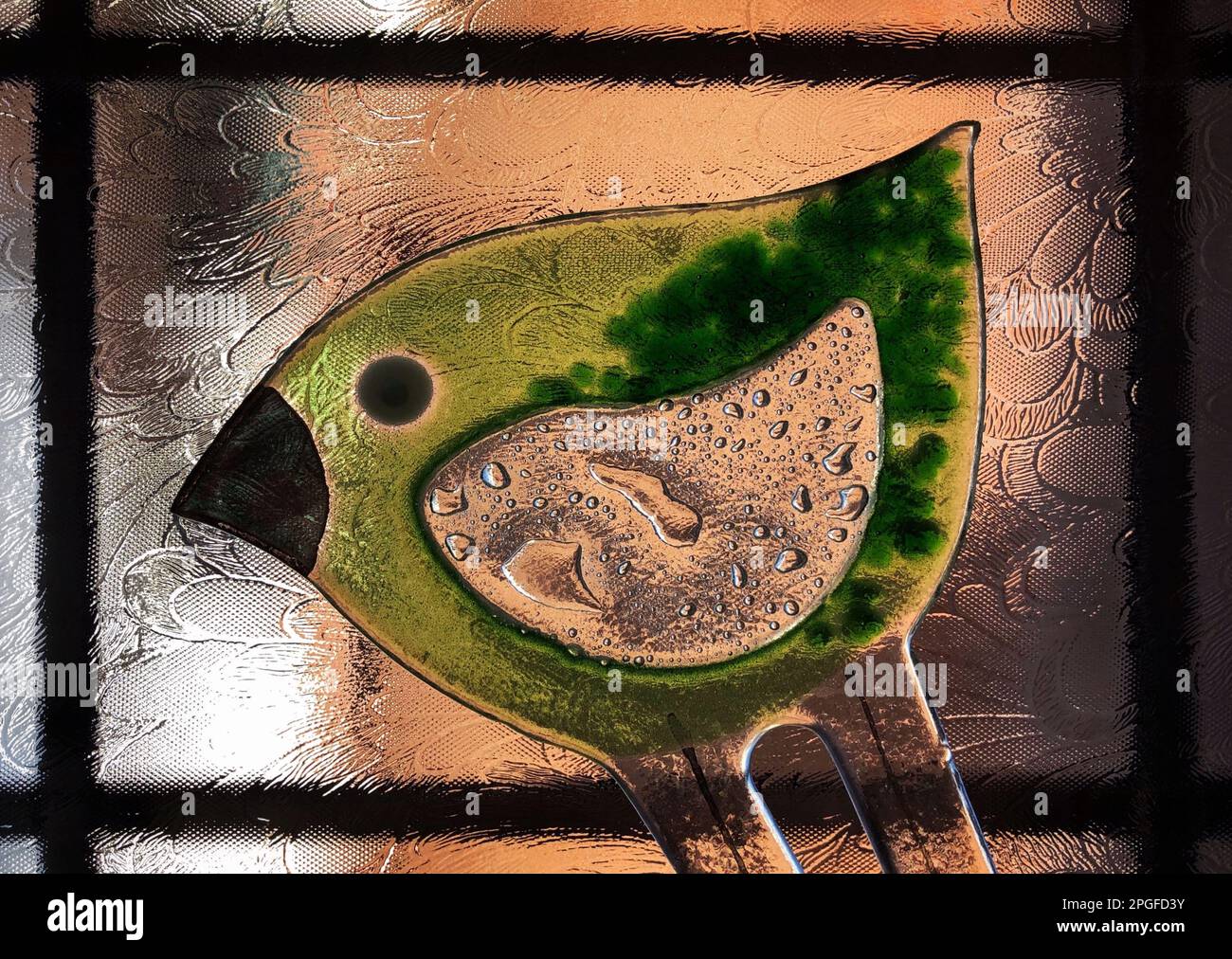 Colour image of a green glass bird artwork Stock Photo