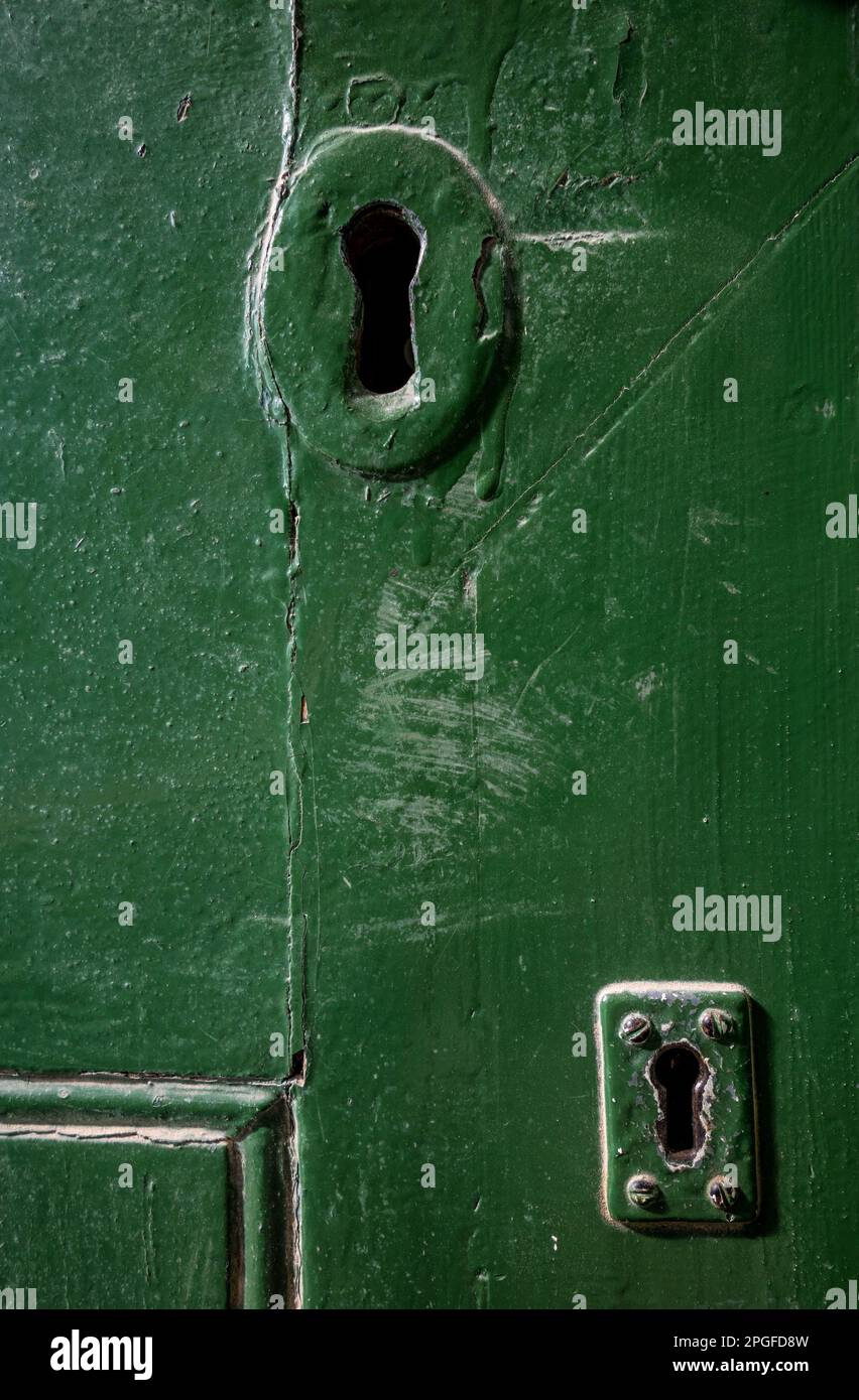 color image of two key holes on an old green wooden door Stock Photo