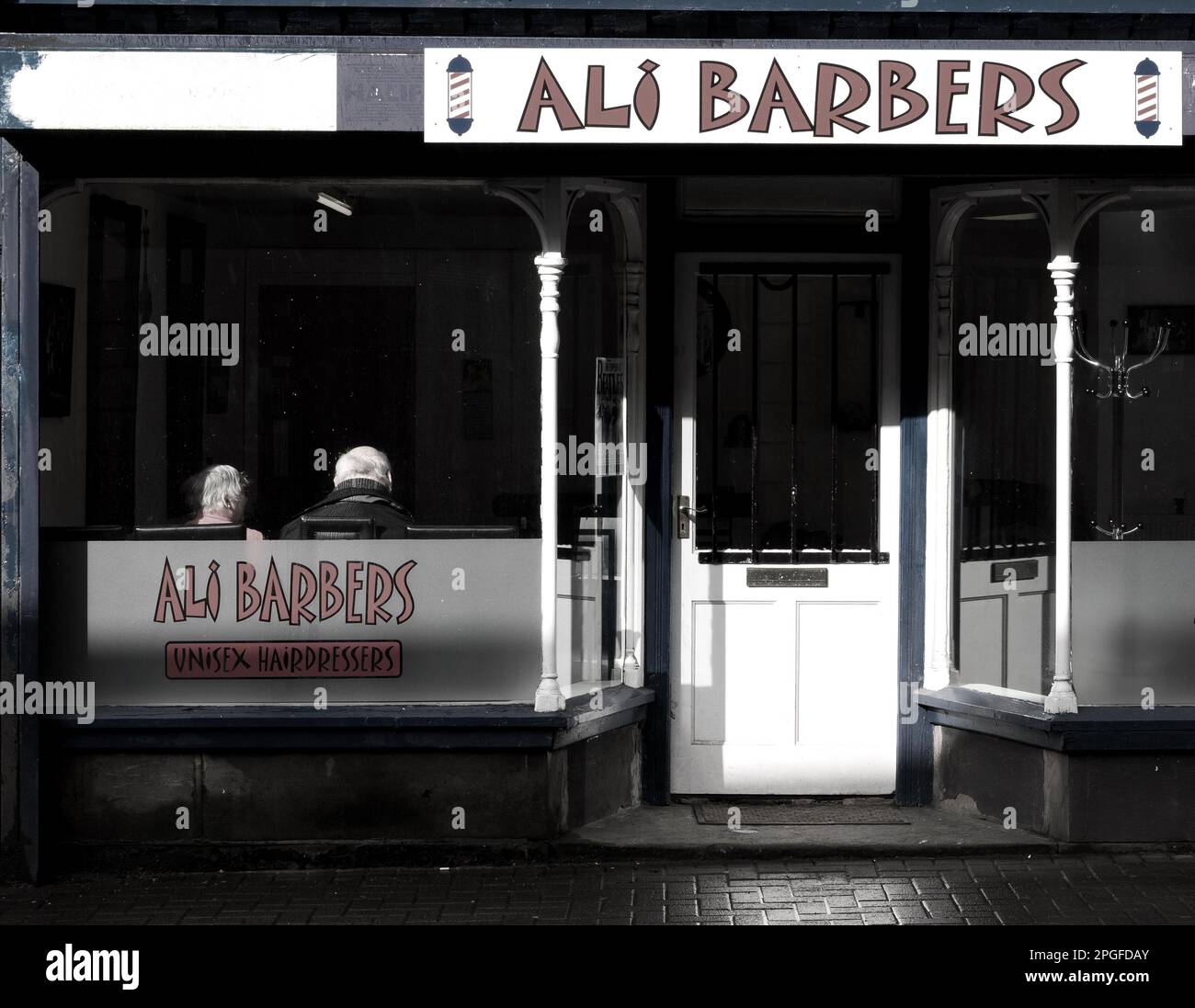 colour image of the outside facad of an english barber shop Stock Photo