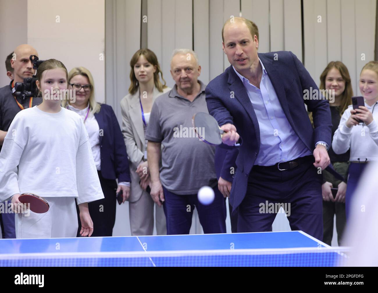 The Prince of Wales plays table tennis during a visit to a