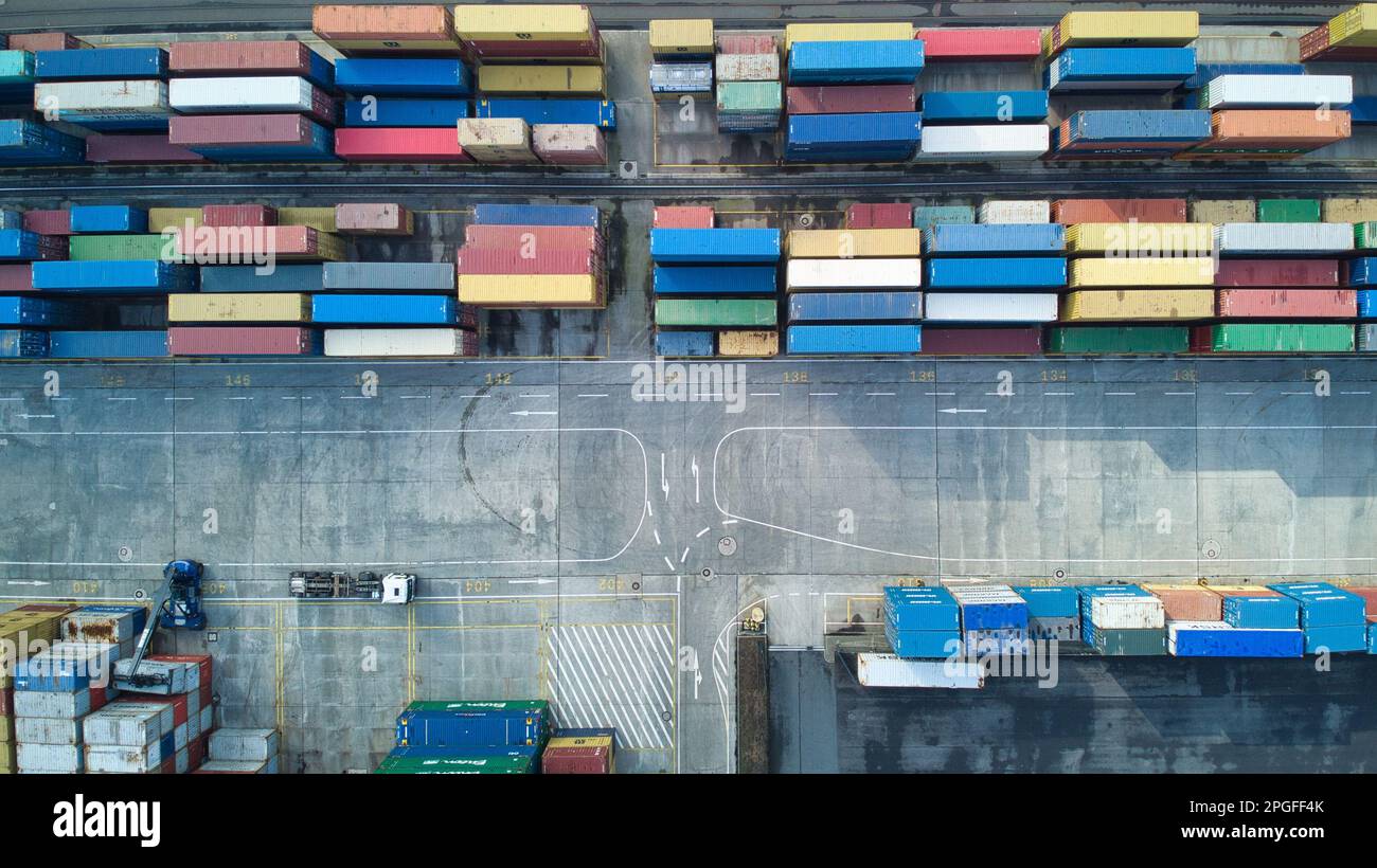 An aerial view of a bustling port, filled with a variety of shipping ...