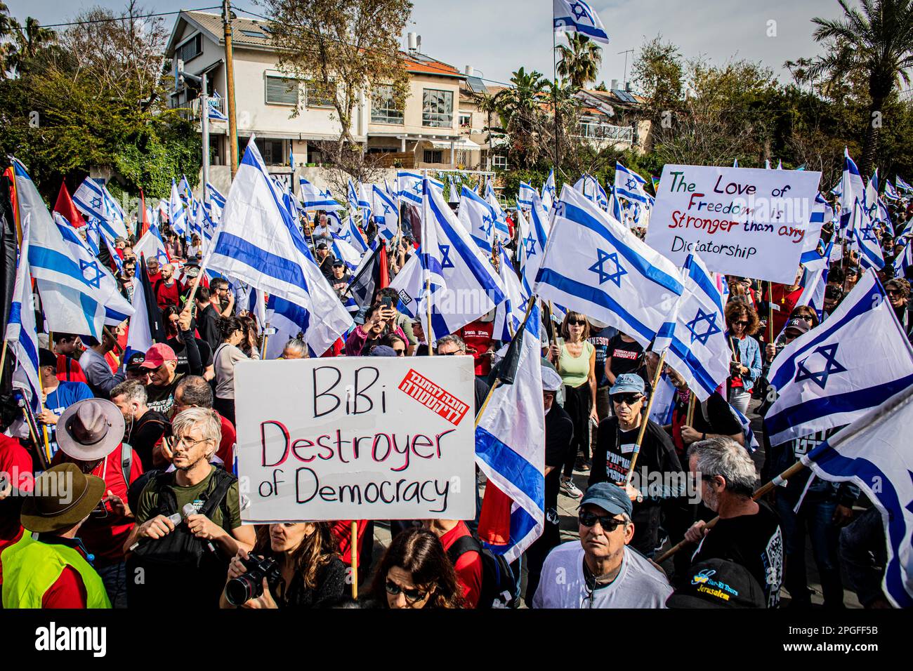 Tel Aviv, Israel. 22nd Mar, 2023. Protestors hold placards and wave the Israeli flags during an anti Judicial reform protest. Protests against the government's judicial overhaul took place in Jerusalem and Tel Aviv with several targeting government ministers as the coalition pushed ahead with its controversial plans. Credit: SOPA Images Limited/Alamy Live News Stock Photo