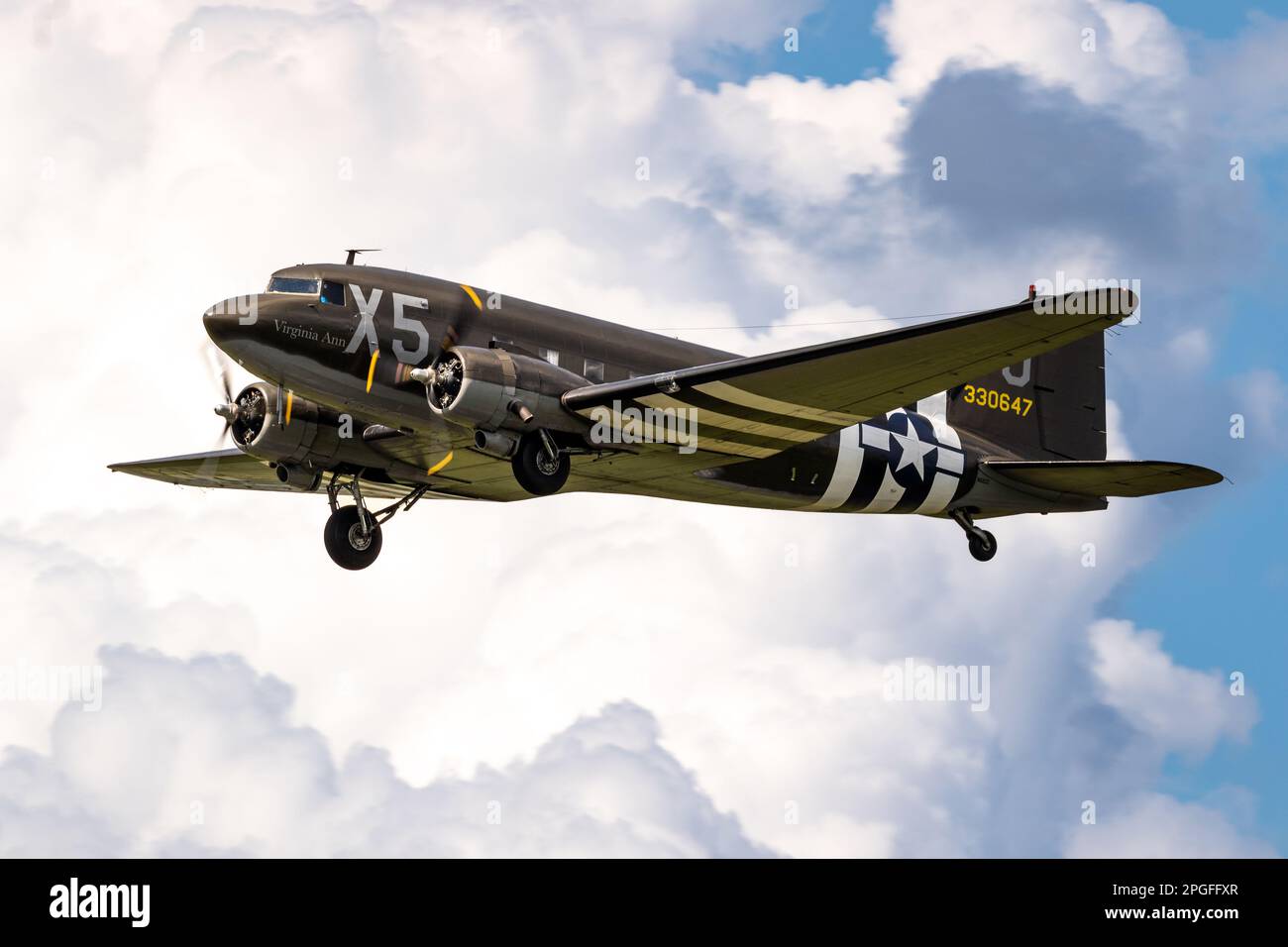Vintage Douglas C-47 Dakota military transport plane in US Army Air Force livery in flight during D-Day 75 memorial flights over Germany. Jagel, Germa Stock Photo