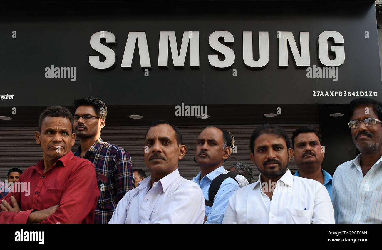 Mumbai, India. 22nd Mar, 2023. People are seen standing below a Samsung logo in Mumbai. Samsung mobile phones are on the list of top 10 mobile phone brands in the year 2023 providing the best of innovation and technology to its customers around the world. (Photo by Ashish Vaishnav/SOPA Images/Sipa USA) Credit: Sipa USA/Alamy Live News Stock Photo
