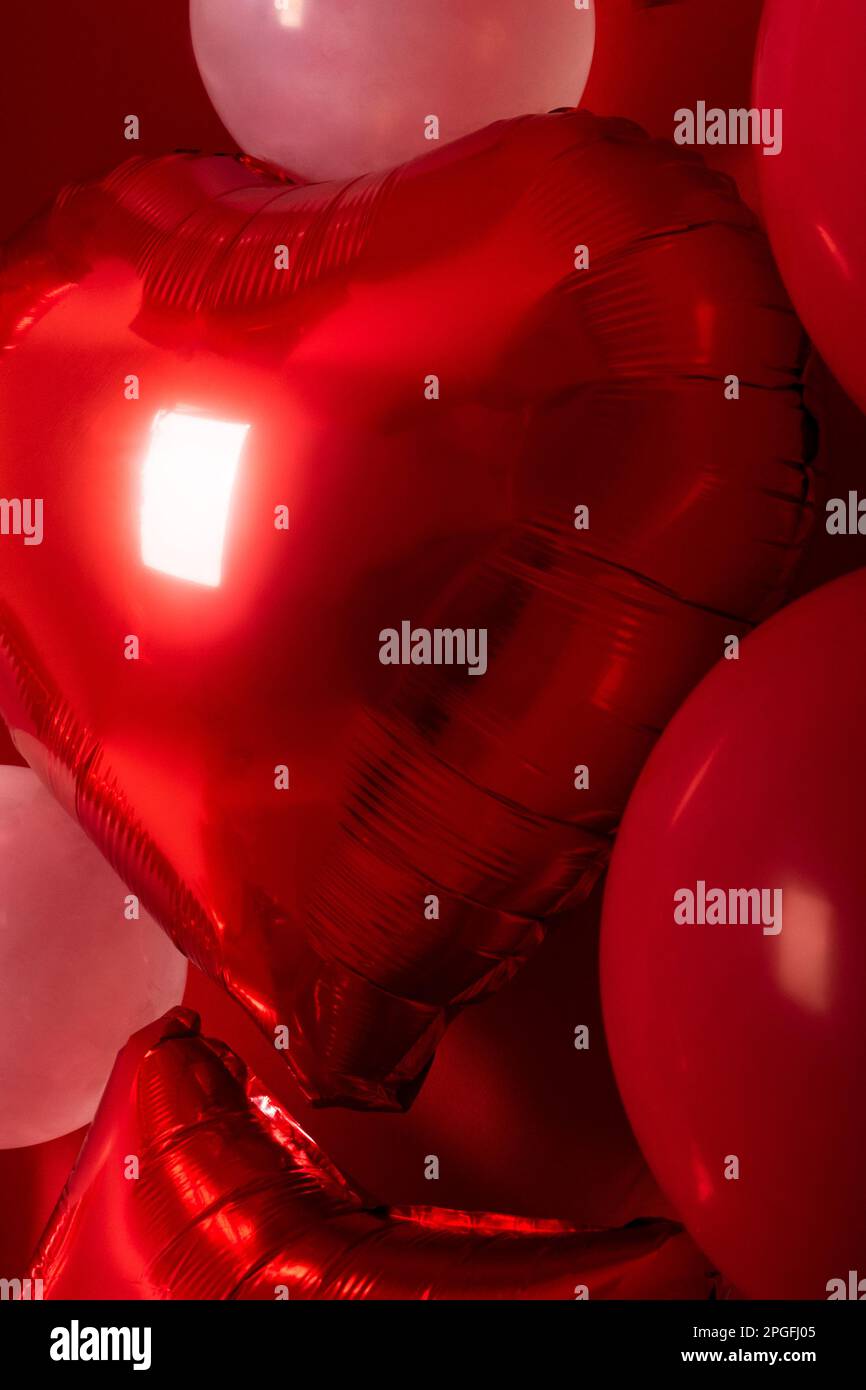 A collection of red and white heart-shaped balloons in a bundle ...