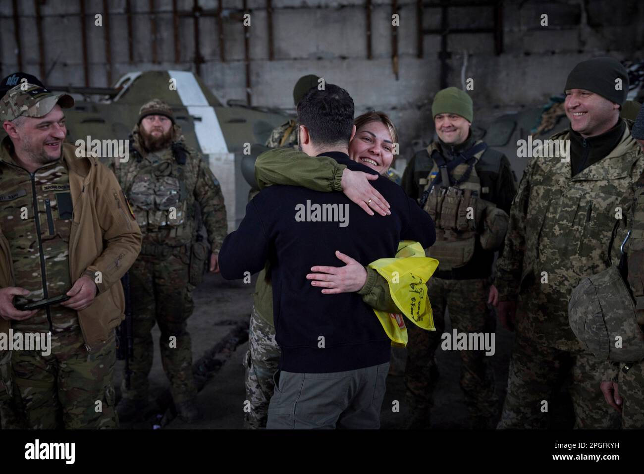 Bakhmut, Ukraine. 22nd Mar, 2023. Ukrainian President Volodymyr Zelenskyy, center, is embraced by a female soldier during a visit to the frontlines positions in the Donetsk region, March 22, 2023 in Bakhmut, Ukraine. Zelenskyy boosted morale and presented state medals to the soldiers defending against the Russian invasion. Credit: Pool Photo/Ukrainian Presidential Press Office/Alamy Live News Stock Photo