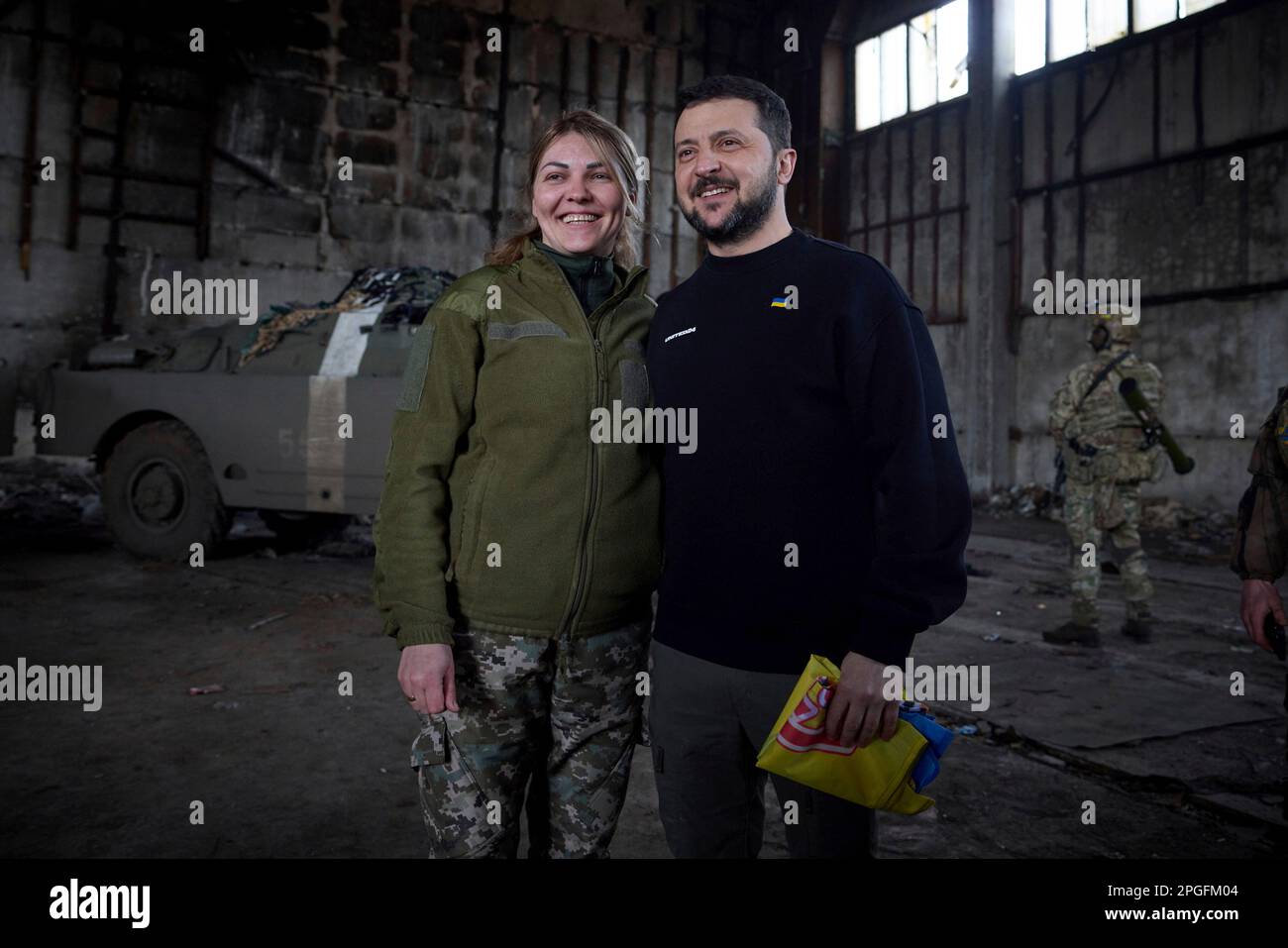 Bakhmut, Ukraine. 22nd Mar, 2023. Ukrainian President Volodymyr Zelenskyy, right, poses with a female soldier during a visit to the frontlines positions in the Donetsk region, March 22, 2023 in Bakhmut, Ukraine. Credit: Pool Photo/Ukrainian Presidential Press Office/Alamy Live News Stock Photo