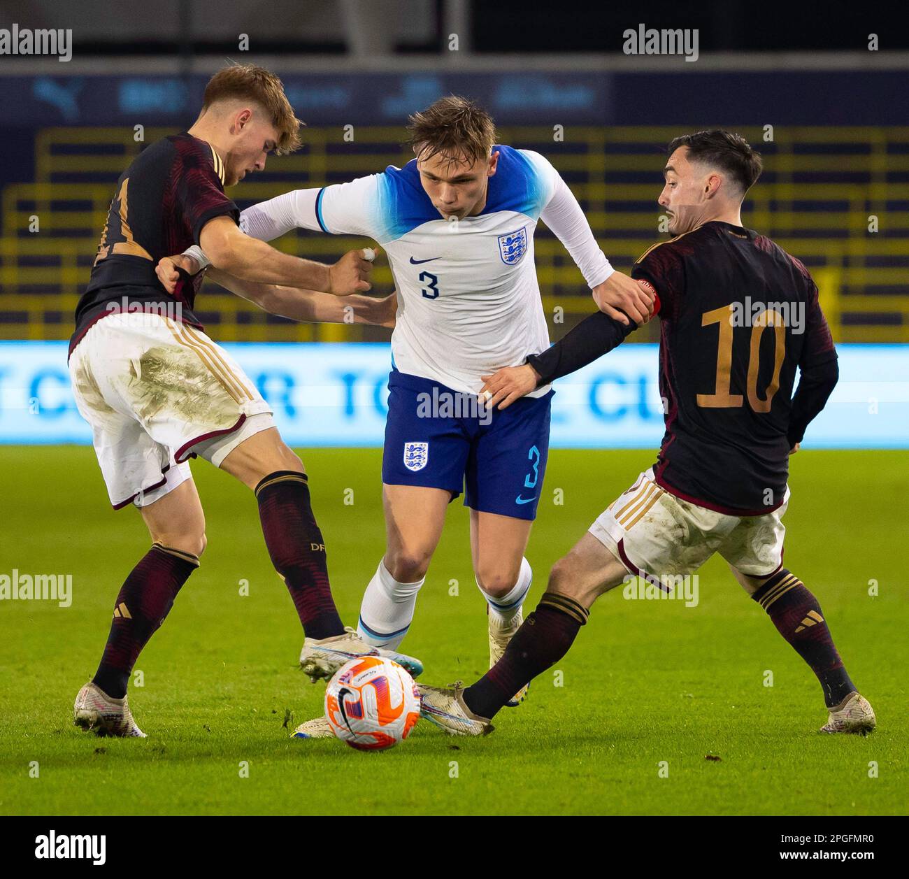 Manchester, UK. 22nd Mar, 2023. Manchester, England, March 22nd 2023: Callum Doyle (3 England) dribbles past two Germany players during the International Friendly football match between England and Germany at the City Football Academy Stadium in Manchester, England. (James Whitehead/SPP) Credit: SPP Sport Press Photo. /Alamy Live News Stock Photo