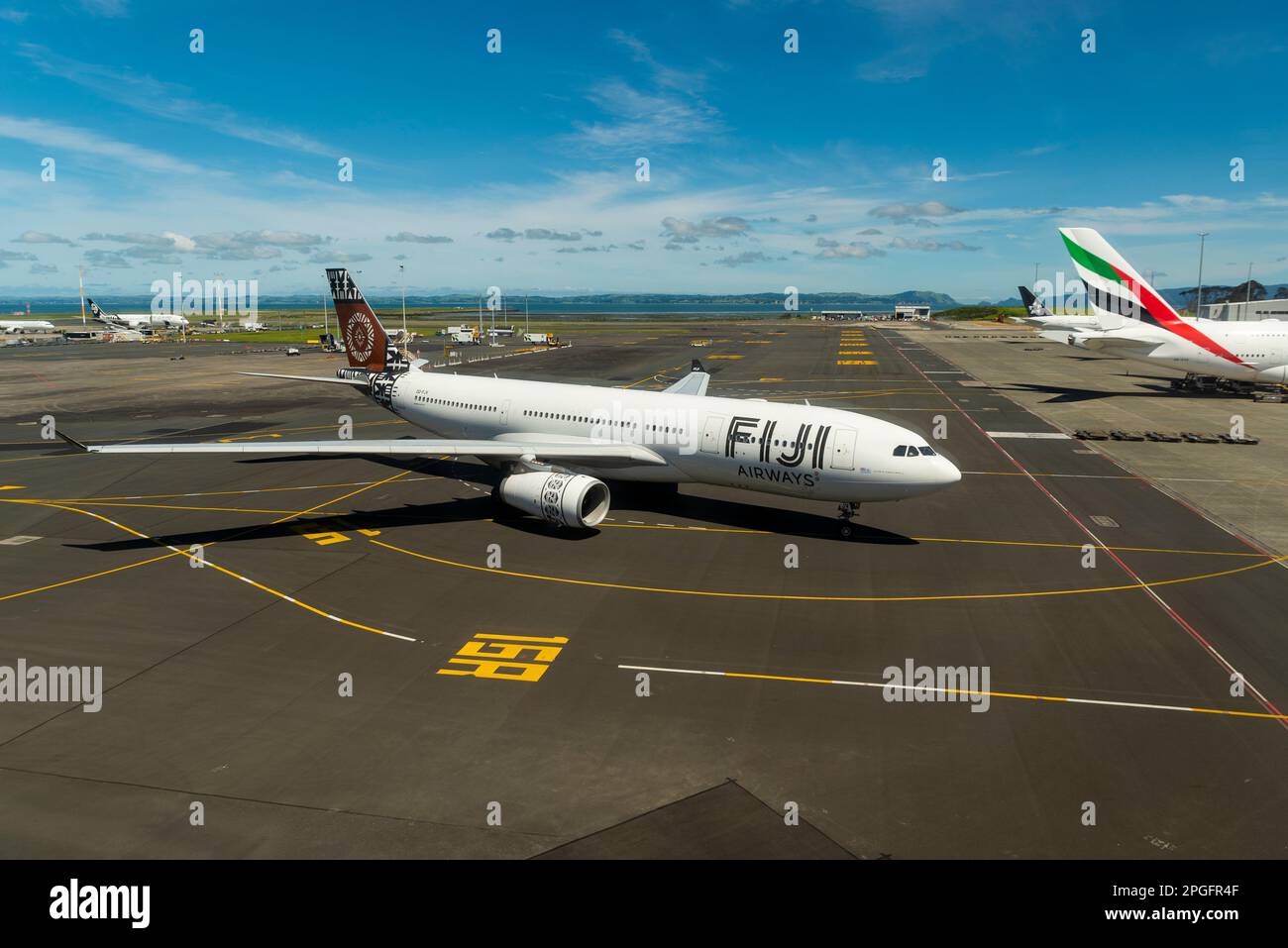 Fiji Airways Airbus A330 airliner jet plane DQ-FJV taxiing to stand at Auckland Airport, New Zealand. Taxiway markings to gate Stock Photo