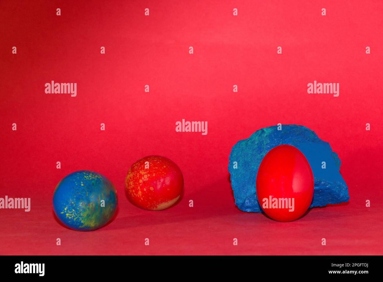 red egg on the blue stone, creative holiday design, happy Easter Stock Photo